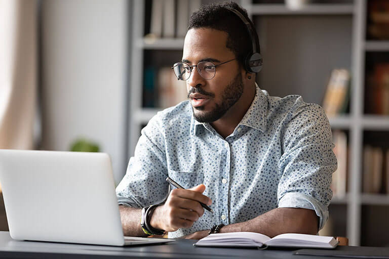 Focused businessman wear headphones study online watching webinar, ©fizkes / Adobe Stock 