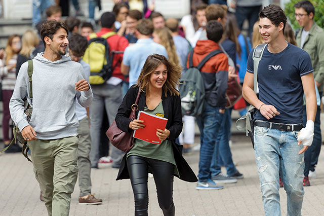 Three ESCP students coming out of a campus