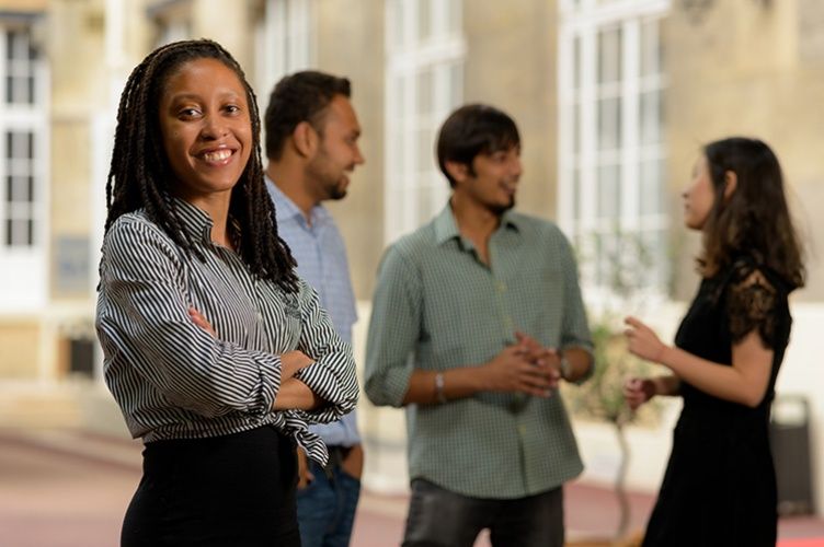 Three ESCP students coming out of a campus